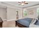 Spacious main bedroom with a tray ceiling, large windows, and ensuite bathroom access at 8016 Parker Mill Trl, Fuquay Varina, NC 27526