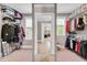 Large walk-in closet featuring built-in shelving and ample storage space at 8016 Parker Mill Trl, Fuquay Varina, NC 27526