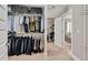 Organized walk-in closet with built-in shelving and convenient access to the bathroom at 8016 Parker Mill Trl, Fuquay Varina, NC 27526