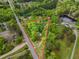 Aerial view of lot showing property lines, and surrounding nature, ponds, and neighborhood at 8175 Nc 27 E, Coats, NC 27521