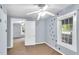 Bedroom with carpet flooring, blue walls, a ceiling fan, and dinosaur accents at 8175 Nc 27 E, Coats, NC 27521