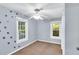 Bedroom with cute dinosaur accents on the walls and a ceiling fan at 8175 Nc 27 E, Coats, NC 27521