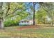 Charming home nestled among mature trees, offering a serene and private setting at 8175 Nc 27 E, Coats, NC 27521