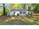 Charming single-story home with a yard surrounded by trees at 8175 Nc 27 E, Coats, NC 27521