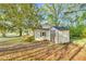 Exterior view of the house and yard featuring a shed on the property at 8175 Nc 27 E, Coats, NC 27521
