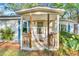 Inviting front porch with wooden railings and a cozy entryway for relaxing and enjoying the outdoors at 8175 Nc 27 E, Coats, NC 27521