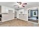 Eat-in kitchen showcasing a ceiling fan, white cabinets, and a convenient doorway to adjacent rooms at 8175 Nc 27 E, Coats, NC 27521