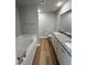 Bathroom featuring wood-style floors, soaker tub, and granite dual vanity at 86 Heatherglenn Cir, Princeton, NC 27569