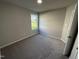 Cozy bedroom featuring plush carpeting, neutral paint, and a bright window at 86 Heatherglenn Cir, Princeton, NC 27569