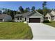 Beautiful home exterior with green siding, a spacious driveway, and a lush green lawn at 86 Heatherglenn Cir, Princeton, NC 27569