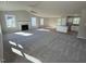 Large open living room with carpet flooring, fireplace, and an adjacent kitchen area at 86 Heatherglenn Cir, Princeton, NC 27569