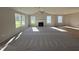 Open-concept living room with a fireplace, ceiling fan, and a combination of carpet and hardwood flooring at 86 Heatherglenn Cir, Princeton, NC 27569