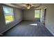 Spacious primary bedroom with tray ceiling, ceiling fan, and sun-filled windows at 86 Heatherglenn Cir, Princeton, NC 27569