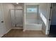 Bright bathroom featuring a tub under a window and a glass door shower at 87 Heatherglenn Cir, Princeton, NC 27569