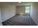Bedroom with carpeted flooring, neutral colored walls, and window with a view at 87 Heatherglenn Cir, Princeton, NC 27569