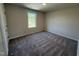 Bedroom with carpeted flooring, a window with a view, and neutral colored walls at 87 Heatherglenn Cir, Princeton, NC 27569