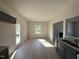 Modern kitchen with gray cabinets, granite countertops, stainless steel appliances, and an open view into the living spaces at 87 Heatherglenn Cir, Princeton, NC 27569