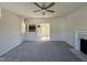 Comfortable living room with plush carpeting, a fireplace, and an open floor plan connecting to the dining area and kitchen at 87 Heatherglenn Cir, Princeton, NC 27569