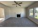 Inviting living room with fireplace, neutral color palette, plush carpeting, and abundant natural light from large windows at 87 Heatherglenn Cir, Princeton, NC 27569