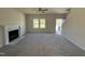 Bright and airy living room featuring neutral walls, plush carpeting, a fireplace, and natural light from the windows at 87 Heatherglenn Cir, Princeton, NC 27569