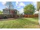 Backyard features a lush lawn, mature trees, and a wood fence, creating a private outdoor oasis at 8812 Forester Ln, Apex, NC 27539