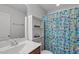 Bathroom features a vanity with storage, a sink and a shower with decorative curtain at 8812 Forester Ln, Apex, NC 27539