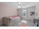 Cozy bedroom features a comfortable daybed, plush carpeting, and soft natural light from the window at 8812 Forester Ln, Apex, NC 27539
