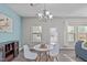 The dining area features a chandelier, a large window, and a small table with chairs at 8812 Forester Ln, Apex, NC 27539