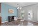 The dining area features a chandelier, a large window, and a small table with chairs at 8812 Forester Ln, Apex, NC 27539