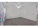 An empty room with grey wood floors, crown molding and blue and white curtains at 8812 Forester Ln, Apex, NC 27539
