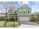 Charming two-story home featuring a two-car garage and manicured lawn at 8812 Forester Ln, Apex, NC 27539