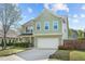 Charming two-story home featuring a two-car garage and manicured lawn at 8812 Forester Ln, Apex, NC 27539