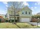 Charming two-story home featuring a two-car garage and manicured lawn at 8812 Forester Ln, Apex, NC 27539