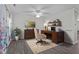 Well-lit home office with dark wood desk, comfortable chair, and decorative shelving at 8812 Forester Ln, Apex, NC 27539