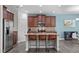 This kitchen features granite counters, stainless appliances, and three stools at the breakfast bar at 8812 Forester Ln, Apex, NC 27539