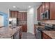 This kitchen features granite counters, stainless appliances, and a stainless sink at 8812 Forester Ln, Apex, NC 27539