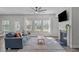 Inviting living room featuring a ceiling fan, fireplace, and great natural light at 8812 Forester Ln, Apex, NC 27539