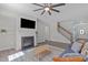 Bright living room with a fireplace, mounted TV, and lots of natural light at 8812 Forester Ln, Apex, NC 27539