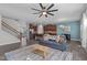 Bright living room showcases an open floor plan, hardwood floors, and a modern ceiling fan at 8812 Forester Ln, Apex, NC 27539