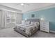 Spacious main bedroom featuring a plush bed, tray ceilings, and calming color palette at 8812 Forester Ln, Apex, NC 27539