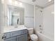 Bright bathroom featuring a shower-tub combo, white subway tile, and a vanity with a gray cabinet at 9220 Yardley Town Dr, Wake Forest, NC 27587