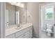 Bathroom featuring a long mirror and white cabinets at 9220 Yardley Town Dr, Wake Forest, NC 27587