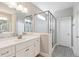 The bathroom features a double sink vanity with a glass enclosed shower at 9220 Yardley Town Dr, Wake Forest, NC 27587