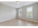 Bedroom featuring two windows letting in natural light and hardwood floors at 9220 Yardley Town Dr, Wake Forest, NC 27587