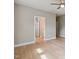 A bedroom featuring hardwood floors and an open doorway to a closet and hallway at 9220 Yardley Town Dr, Wake Forest, NC 27587