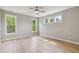 This is a bedroom featuring hardwood floors, a ceiling fan, and natural light from the windows at 9220 Yardley Town Dr, Wake Forest, NC 27587