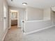 Bright hallway with gray walls, gray carpet and view into the bathroom with modern fixtures at 9220 Yardley Town Dr, Wake Forest, NC 27587