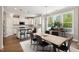 Eat-in kitchen features white cabinets, granite counters, stainless appliances, and stylish chandelier at 9220 Yardley Town Dr, Wake Forest, NC 27587