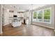 Bright, modern kitchen with white cabinetry, granite countertops, and stainless steel appliances at 9220 Yardley Town Dr, Wake Forest, NC 27587