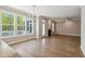 Light-filled living space with large windows, hardwood floors, and views of the outdoors at 9220 Yardley Town Dr, Wake Forest, NC 27587